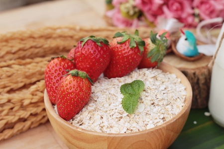 Oatmeal with milk and fresh strawberry for healthの写真素材