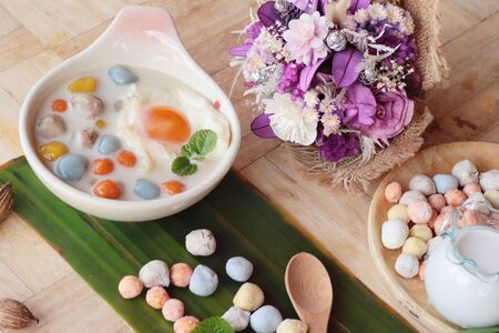 Colorful dumplings in coconut milk and eggの写真素材