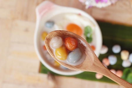 Colorful dumplings in coconut milk and eggの写真素材
