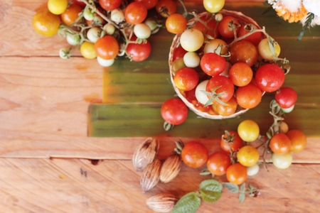 Fresh tomatoes for cooking on wood backgroundの写真素材