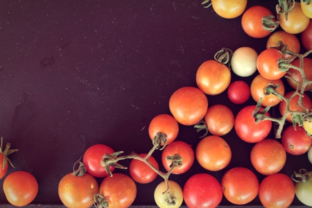 Fresh tomatoes for cooking on black backgroundの写真素材