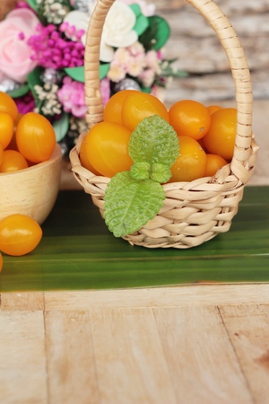 Fresh yellow tomatoes organic on wood backgroundの写真素材