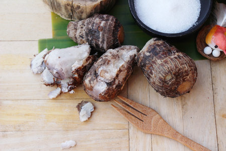 Boiled taro with sugar on wood backgroundの写真素材