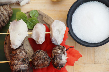 Boiled taro with sugar on wood background