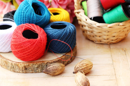 Colorful thread for sewing on wood backgroundの写真素材