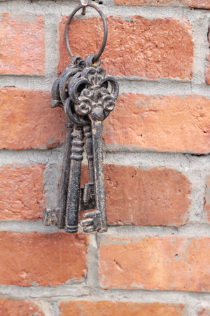Old key to hang on brick wall