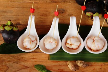 Mangosteen fruit is delicious on wood backgroundの写真素材