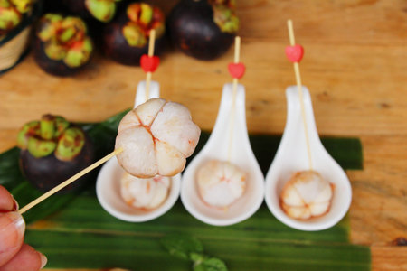 Mangosteen fruit is delicious on wood backgroundの写真素材