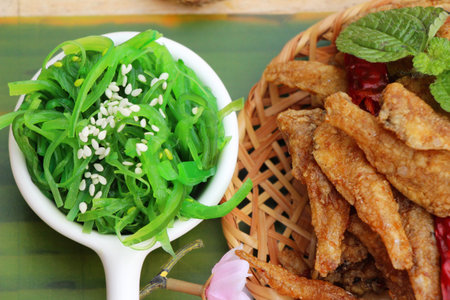 Seaweed salad with fried fish is delicious
