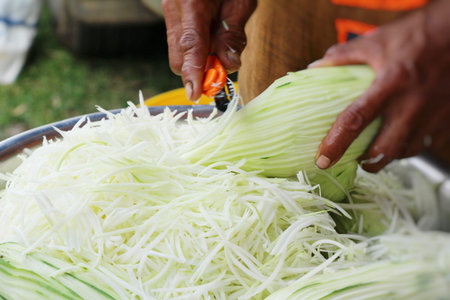 Chop fresh papaya for cooking in market