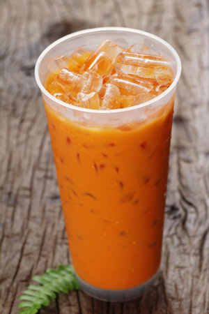 Iced milk tea delicious on wood background