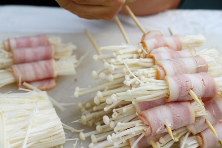 Making bacon wrapped mushrooms delicious for grilledの写真素材