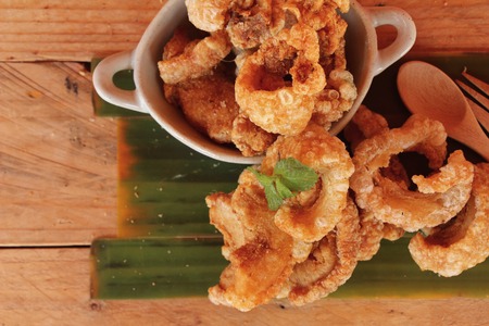 Fried pork skin is delicious on wood backgroundの写真素材