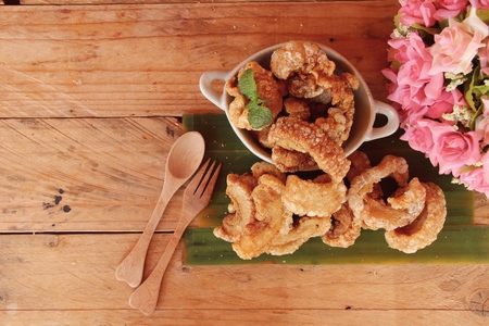 Fried pork skin is delicious on wood backgroundの写真素材