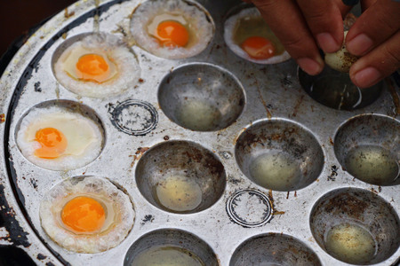 Grilled quail eggs in a pan pitsの写真素材