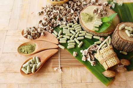 Moringa capsule for health on wood backgroundの写真素材