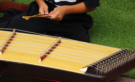 Children playing dulcimer ,Thailandの写真素材