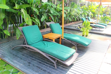 Cozy daybed with umbrellas by the poolの写真素材