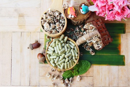 Moringa capsule for health on wood backgroundの写真素材