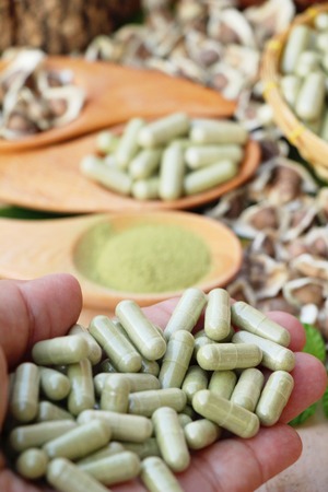 Moringa capsule for health on wood backgroundの写真素材