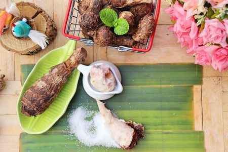 Boiled taro with sugar on wood backgroundの写真素材