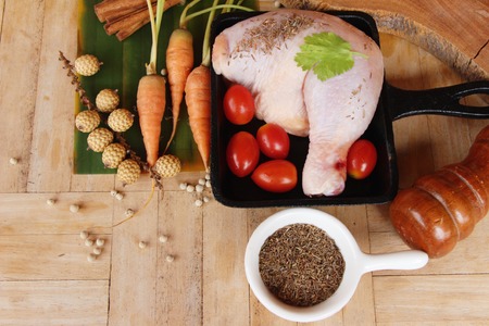 Fresh chicken legs for cooking on wood backgroundの写真素材