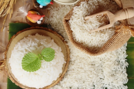 cooked jasmine rice and raw organic riceの写真素材
