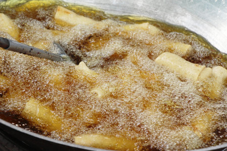 fried spring rolls in pan at street food
