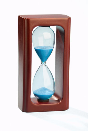 Mahogany hourglass with blue sand isolated on white background