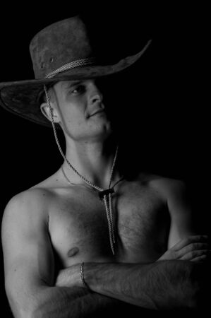 Handsome muscular male on black background. Studio low-key portrait.の写真素材
