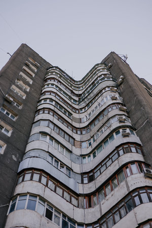 Wavy Soviet multi-storey residential building with round balconies wave shapes. City architecture of...