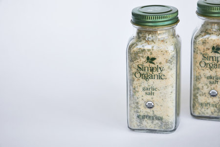 Two jars of garlic salt and herbs seasoning spices, Simply Organic brand. Glass container with green aluminum lid, recyclable packaging. iHerb online shopping. Bishkek, Kyrgyzstan - 8 Dec 2023のeditorial素材
