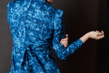 Back of Blue spotted dress, fabric belt tied with bow. Womens clothing item made thick cotton fabric...