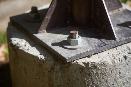 Bolt and nut, screw, gasket. Fastening a metal pole, structures to a concrete base. Fasteners, bolts...
