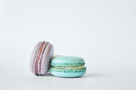 Stack of two colorful French Macarons, cakes with different flavors, mint, apple, current flavor....