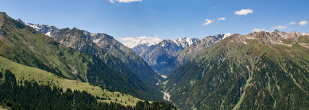 Karakol gorge banner, Kyrgyzstan. Summer mountain landscape, green forest, high mountains and snowy...