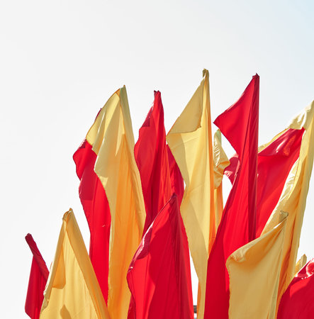 Red and yellow festive flags flutter in the wind