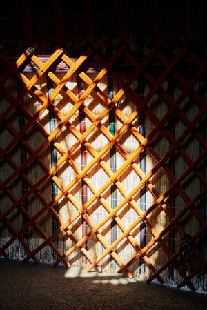 Kerege - wooden internal stiffening ribs inside yurt. Light and shadow. Traditional nomad housingの写真素材