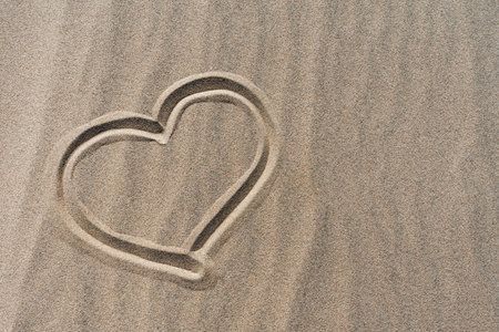 hand drawn heart on dry sand in desertの写真素材