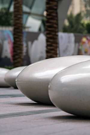 Seats in the shape of smooth large stones in a public park. Unusual appearance of the bench, a place to sit and relaxの写真素材