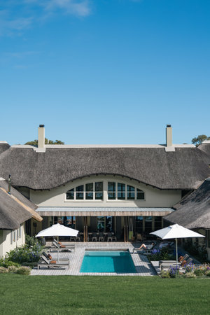 Green lawn, building and swimming pool on hotel territory.の写真素材