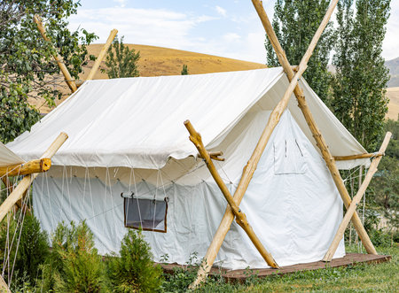 Modern white luxury tent. Glamping housing for summer vacation, camping holidays.の写真素材