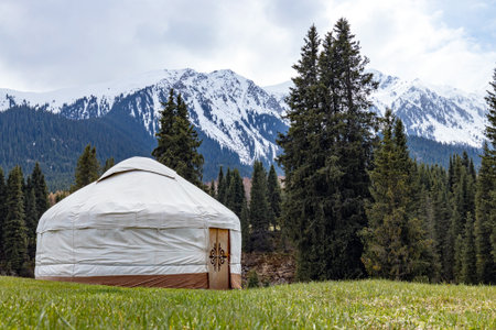 Camping in mountains, Kyrgyzstan. Traditional house of kyrgyz people, white yurt.の写真素材
