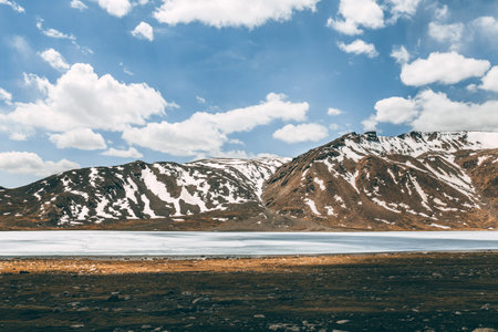 A frozen lake in the mountains. Arabel High Plateau in the Barskoon Mountain Gorge, Kyrgyzstan....