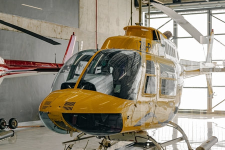 Yellow tourist helicopter in hangar, rotary-wing aircraftの写真素材