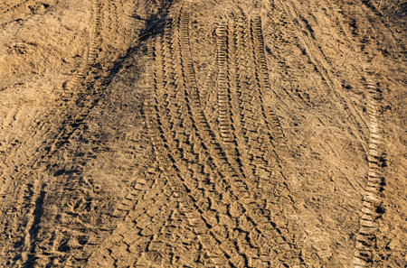 Wheel tracks on the country road. Tire track on a dusty rural road.の写真素材