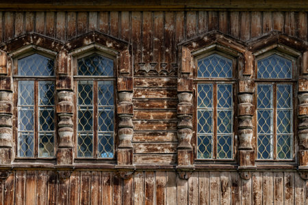 Wooden windows with metal bars in old wooden house.