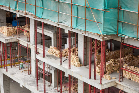 A construction site for an apartment building. Piles of bricks are prepared for the construction of...
