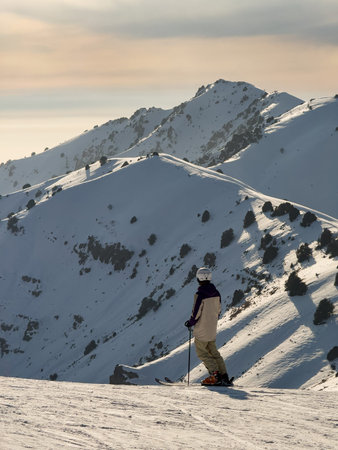 Skier watching the sunset in the mountains.の写真素材