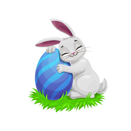 Easter holiday vector bunny or rabbit on easter egg hunt, egghunting party. Gray cartoon bunny on green grass holding a painted egg with blue stripe pattern, Christian religion holidayのイラスト素材